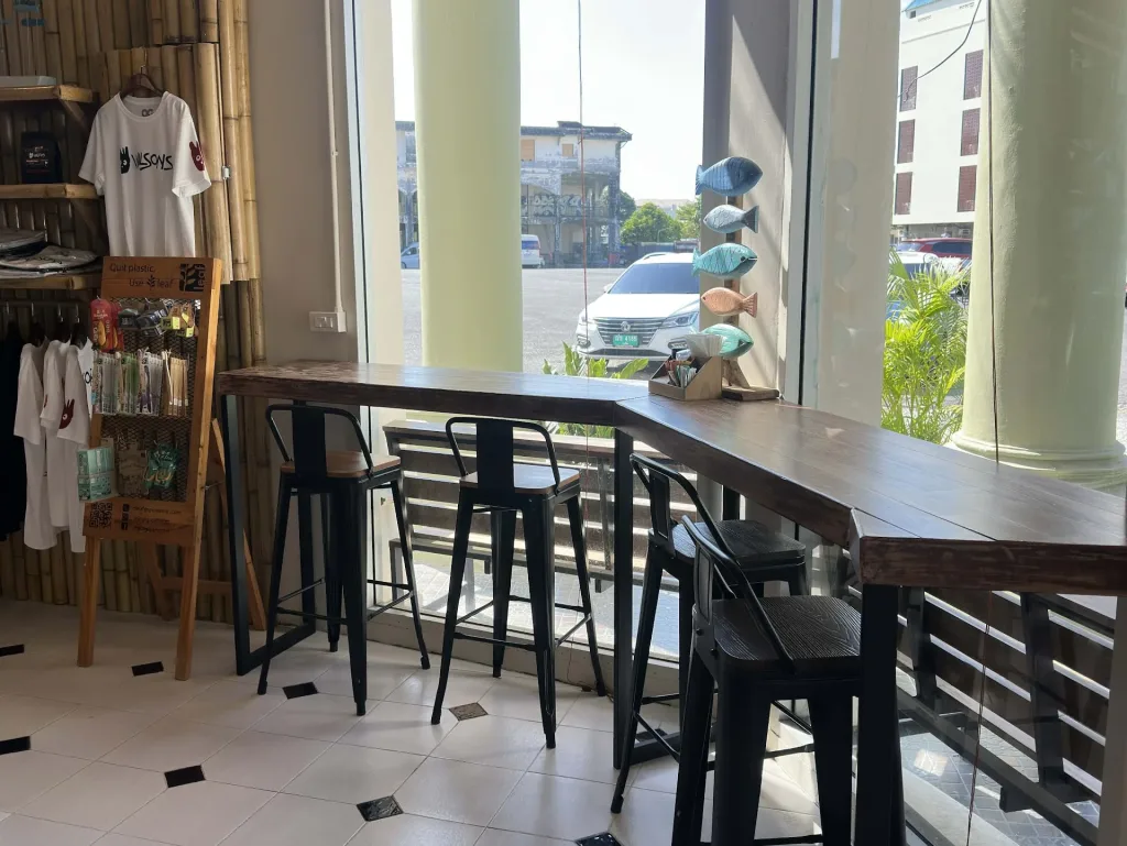 Window seating area inside Wilson’s Cafe Phuket Town overlooking Bangkok Road in Old Town