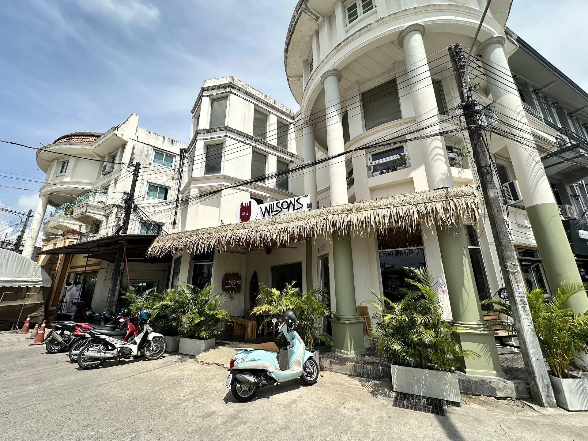Street view of Wilson’s Cafe Phuket Town with outdoor seating and Old Town architecture on Bangkok Road.